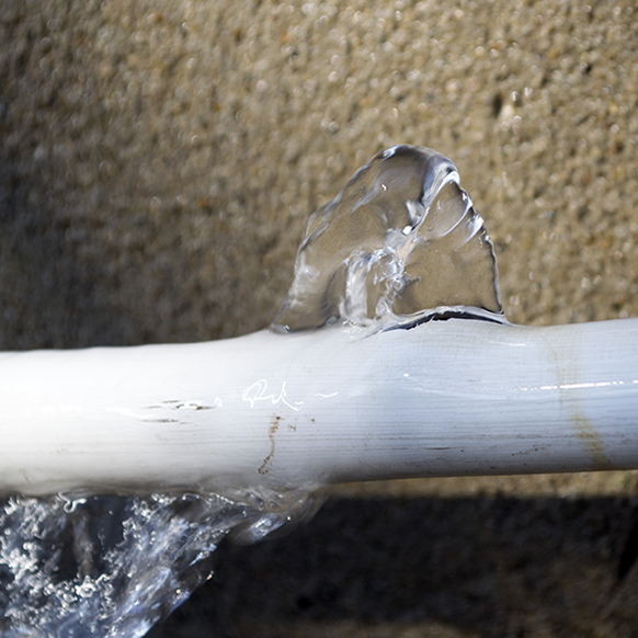Close up of a water pipe broken and water rushing out