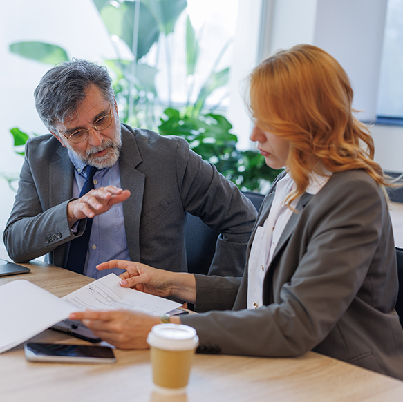 Man and woman discussing actuarial topics about insurance in meeting