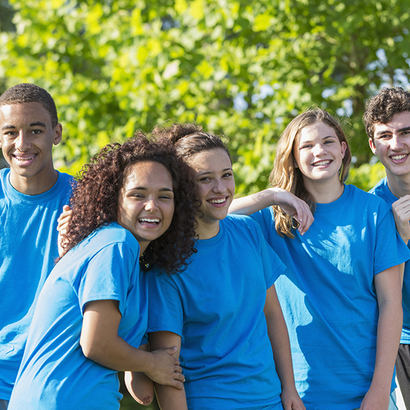 Boys and Girls Club teenagers outside participating in team activities
