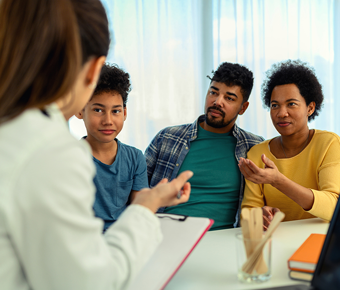 Hispanic family with counselor participating in support group assistance