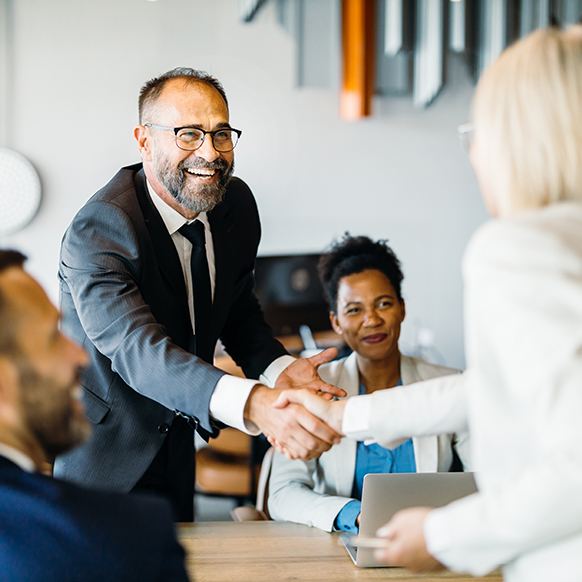 Insurance team meeting with agent partner and shaking hands