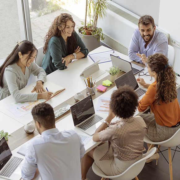 Aerial view of BHS underwriting team collaborating around a table