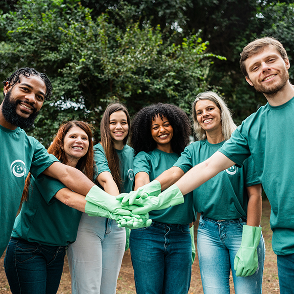 Human services team with hands together as they serve others