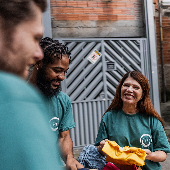 Smiling Worker holding t-shirt